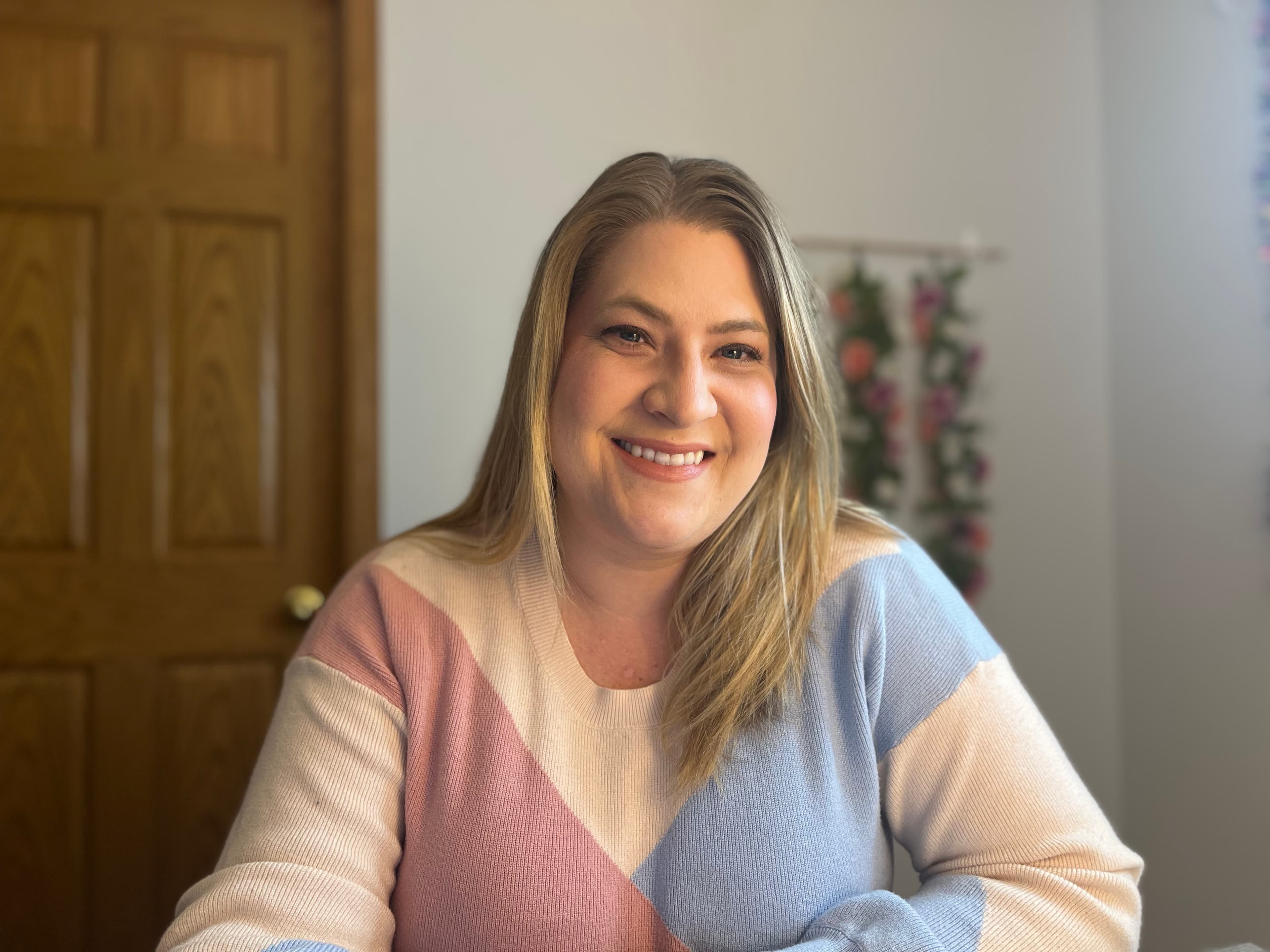 Steph smiling warmly during a video consultation